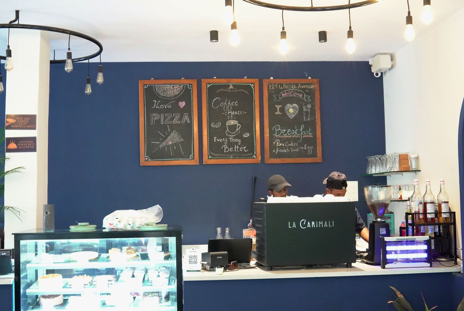 Inside 129 Whiskk. Avenue: chalkboard menus, pastry case and La Carimali espresso machine